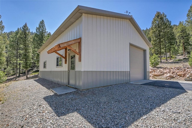 96 Garnet Ln, Pine, CO 80470 - view of side of property featuring a detached garage, driveway, and an outbuilding