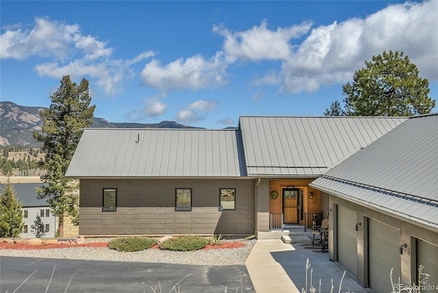 96 Garnet Ln, Pine, CO 80470 - view of property featuring a garage, a mountain view, and driveway