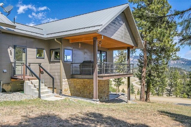 96 Garnet Ln, Pine, CO 80470 - view of side of home with a balcony, a metal roof, and stone siding