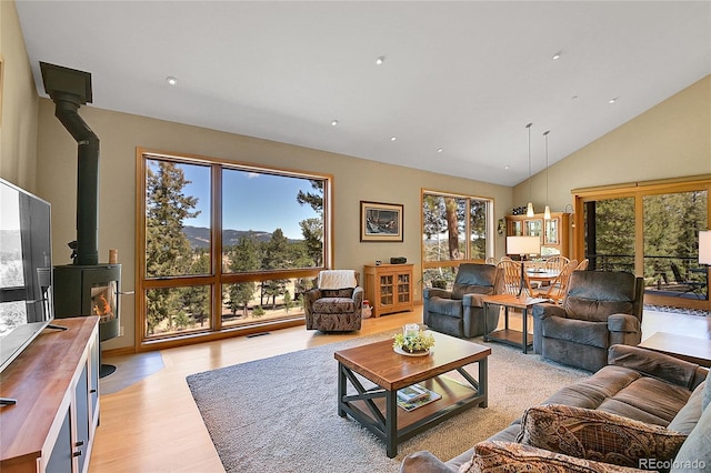 96 Garnet Ln, Pine, CO 80470 - living room with a wood stove, light wood-type flooring, high vaulted ceiling, and recessed lighting