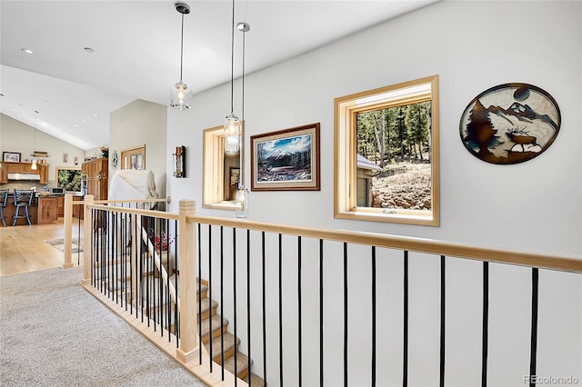96 Garnet Ln, Pine, CO 80470 - hallway featuring vaulted ceiling, plenty of natural light, an upstairs landing, and light carpet