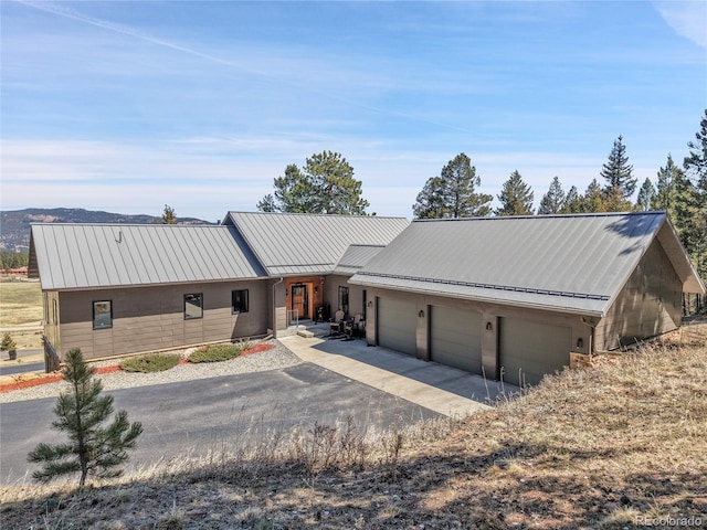 96 Garnet Ln, Pine, CO 80470 - view of front of house featuring asphalt driveway, a garage, and a metal roof