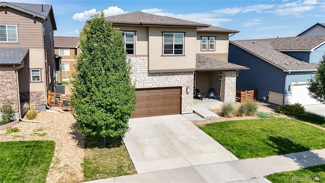 view of front of home featuring a garage and a front yard