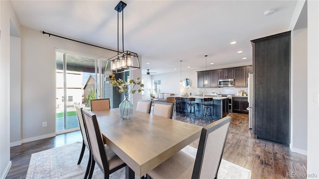 dining space featuring sink and light wood-type flooring