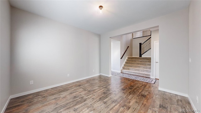 empty room with hardwood / wood-style flooring