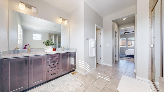 bathroom featuring a shower with door, vanity, ceiling fan, and a healthy amount of sunlight