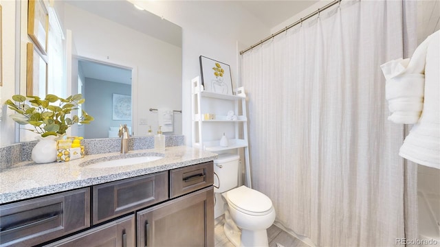 bathroom featuring vanity, toilet, and a shower with shower curtain