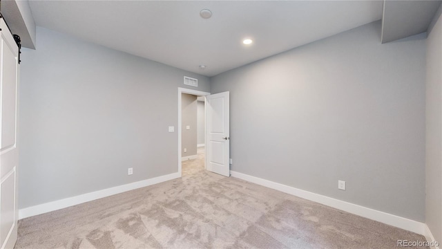 empty room featuring light carpet