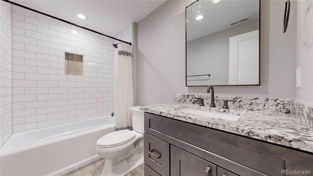 full bathroom with vanity, toilet, and shower / bath combo