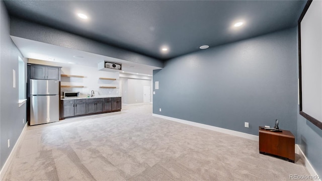 unfurnished living room featuring light colored carpet and sink