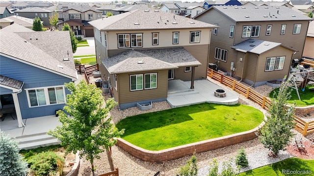 back of house featuring central AC, a lawn, and a patio area