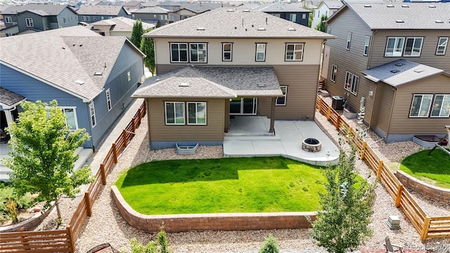 rear view of property with a lawn, a patio area, and central AC unit