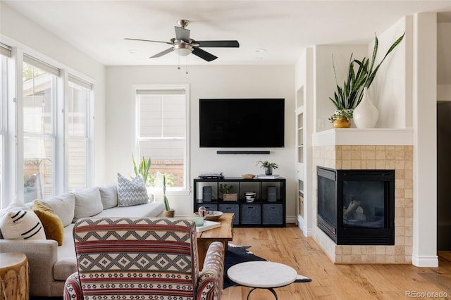 10069 E 28th Ave, Denver, CO 80238 - living area featuring wood finished floors, a ceiling fan, and a tile fireplace