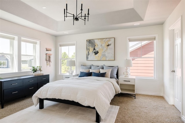 10069 E 28th Ave, Denver, CO 80238 - bedroom featuring a chandelier, a raised ceiling, and light colored carpet