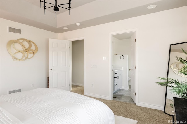 10069 E 28th Ave, Denver, CO 80238 - bedroom featuring light colored carpet, a chandelier, and connected bathroom
