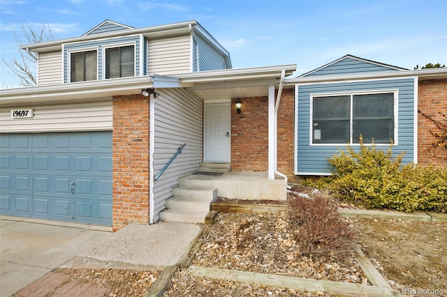 traditional-style home featuring an attached garage, concrete driveway, and brick siding