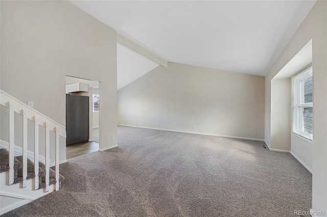 unfurnished living room featuring baseboards, carpet flooring, stairway, and lofted ceiling with beams