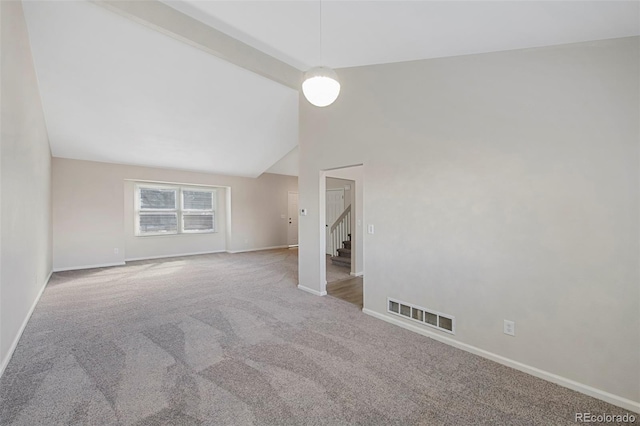 spare room featuring baseboards, visible vents, stairway, carpet floors, and high vaulted ceiling