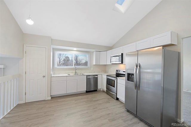 kitchen featuring light countertops, appliances with stainless steel finishes, and white cabinets