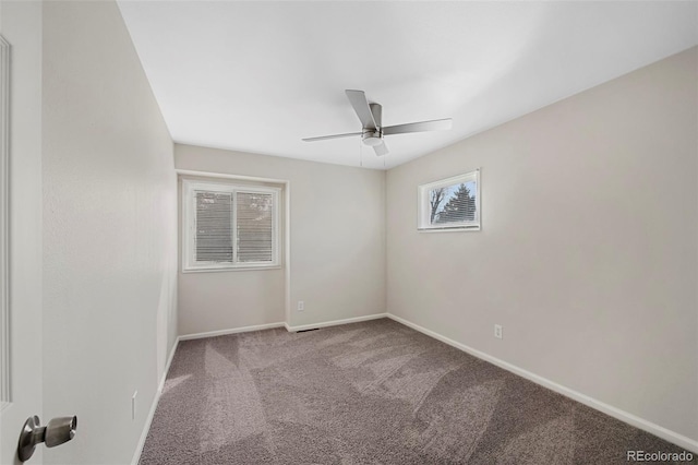 unfurnished room with carpet, a ceiling fan, and baseboards