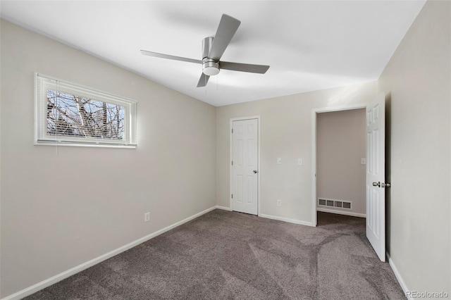 unfurnished bedroom with carpet, visible vents, ceiling fan, and baseboards