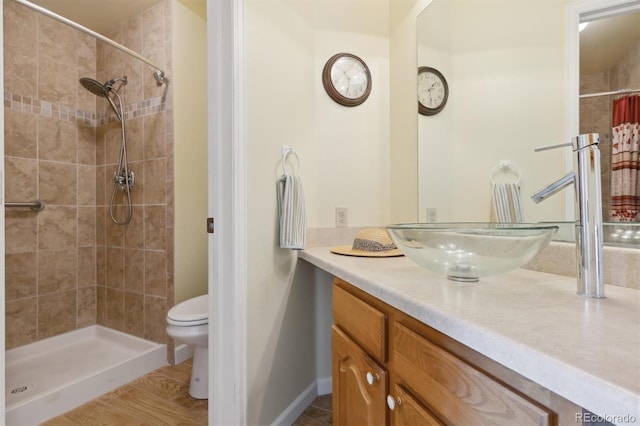 bathroom with toilet, vanity, wood-type flooring, and a shower with shower curtain