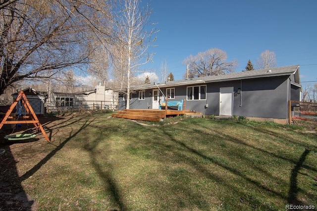 811 W Main St, Buena Vista, CO 81211 - back of property with a lawn, a wooden deck, stucco siding, and fence