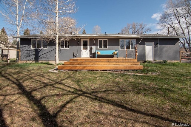 811 W Main St, Buena Vista, CO 81211 - rear view of house with a lawn, a deck, and stucco siding