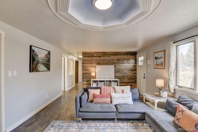 811 W Main St, Buena Vista, CO 81211 - living area featuring baseboards, wood walls, a textured ceiling, and wood finished floors