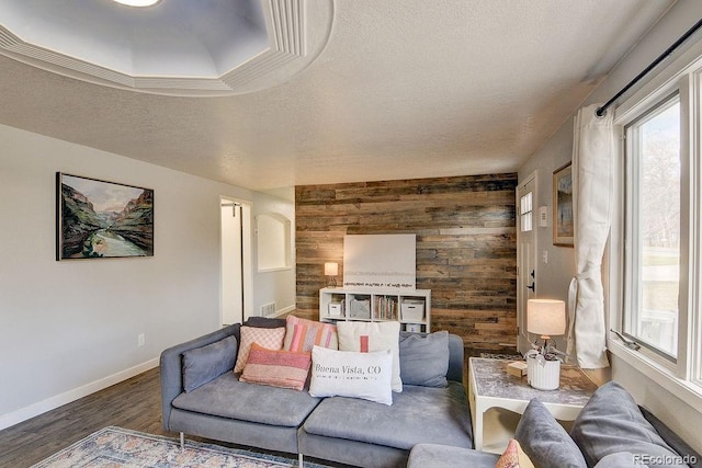 811 W Main St, Buena Vista, CO 81211 - living area featuring a textured ceiling, wood walls, wood finished floors, and baseboards