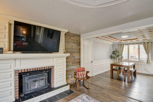 811 W Main St, Buena Vista, CO 81211 - living area with a textured ceiling, coffered ceiling, ornamental molding, wood finished floors, and a wood stove