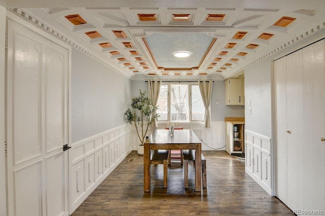 811 W Main St, Buena Vista, CO 81211 - dining room with a wainscoted wall, coffered ceiling, dark wood-type flooring, and a decorative wall
