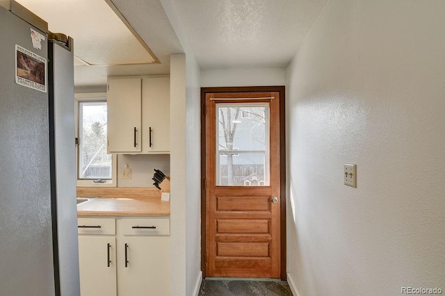 811 W Main St, Buena Vista, CO 81211 - entryway with baseboards, a textured ceiling, and a textured wall