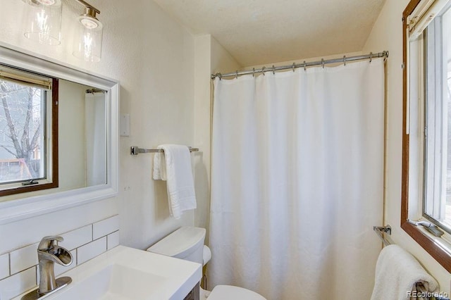811 W Main St, Buena Vista, CO 81211 - full bathroom featuring toilet, a shower with curtain, vanity, and decorative backsplash