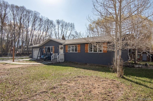 811 W Main St, Buena Vista, CO 81211 - view of front of house featuring an attached garage and a front yard