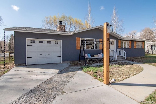 811 W Main St, Buena Vista, CO 81211 - ranch-style house featuring a chimney, driveway, stucco siding, and a garage