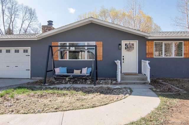 811 W Main St, Buena Vista, CO 81211 - view of front of house featuring an attached garage, stucco siding, and a chimney