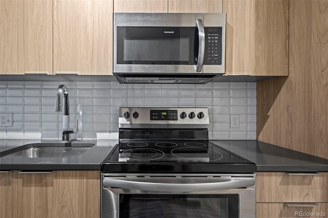 kitchen featuring backsplash, sink, stainless steel appliances, and light brown cabinets