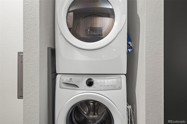 clothes washing area with stacked washer / drying machine