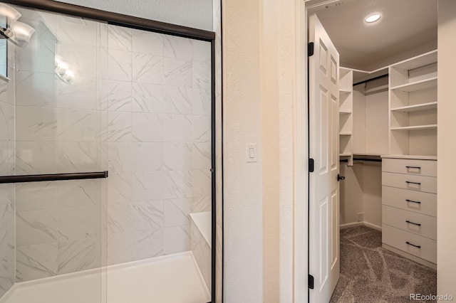 21701 E 50th Dr, Aurora, CO 80019 - bathroom featuring tiled shower and a spacious closet