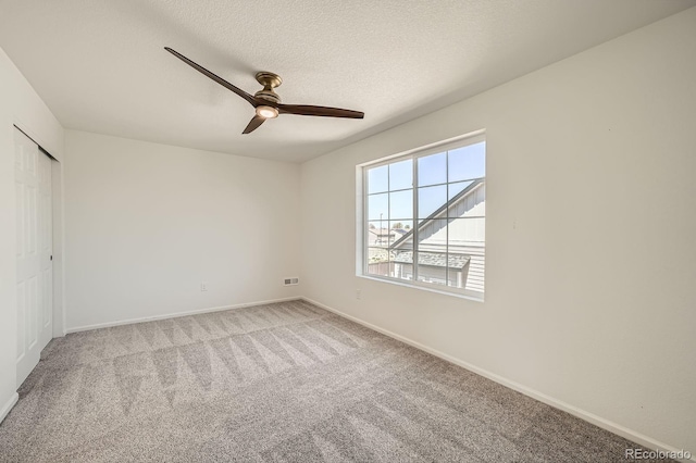 21701 E 50th Dr, Aurora, CO 80019 - unfurnished bedroom featuring carpet floors, baseboards, a ceiling fan, a textured ceiling, and a closet