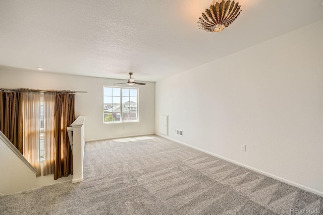 21701 E 50th Dr, Aurora, CO 80019 - carpeted spare room featuring a ceiling fan, baseboards, and a textured ceiling
