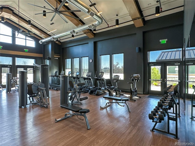 21701 E 50th Dr, Aurora, CO 80019 - exercise room featuring french doors, a towering ceiling, wood finished floors, and beamed ceiling