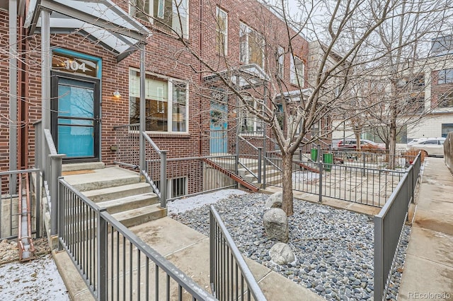 view of exterior entry with brick siding