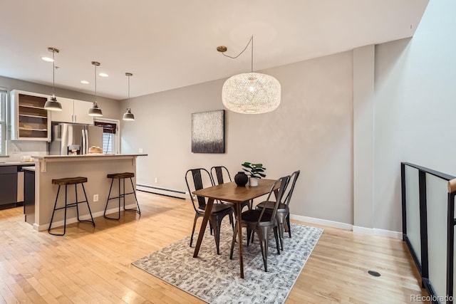 dining area featuring baseboards, recessed lighting, a baseboard radiator, and light wood-style floors