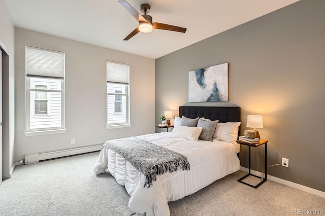 carpeted bedroom featuring a baseboard heating unit, baseboards, and a ceiling fan