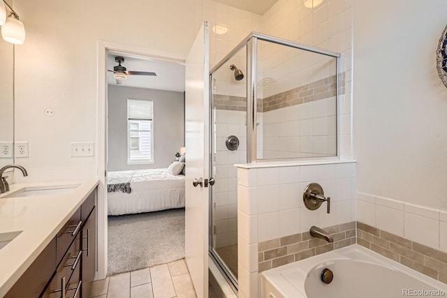 full bathroom with ensuite bathroom, a bathing tub, a sink, double vanity, and a stall shower