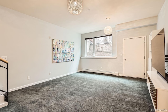 empty room with baseboard heating, dark carpet, and baseboards