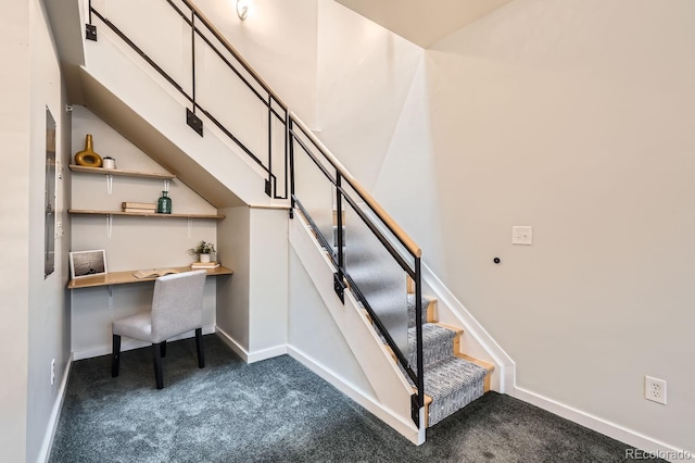 stairs featuring baseboards, carpet flooring, and built in study area