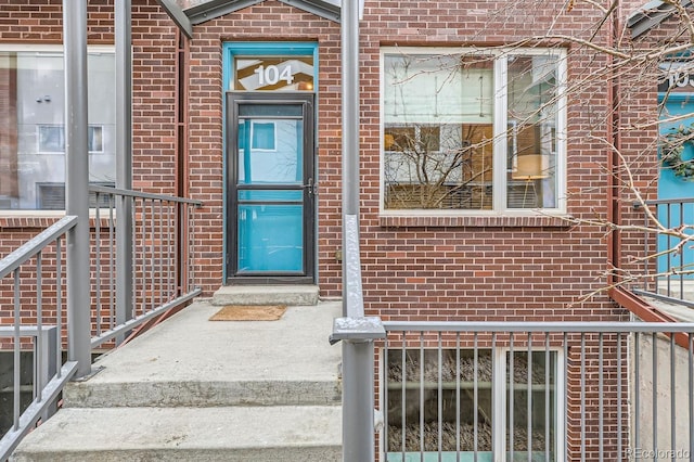 view of exterior entry with brick siding